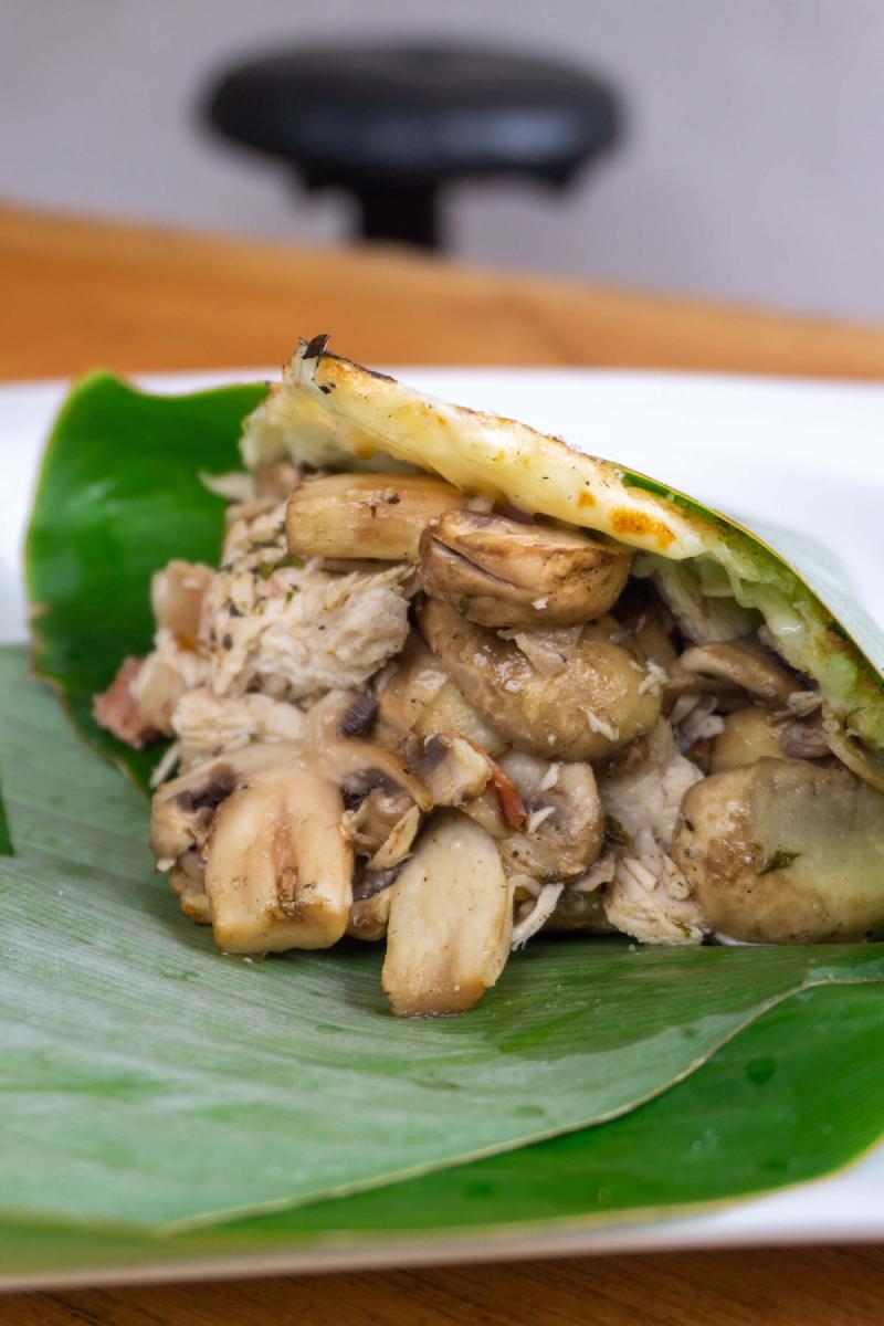 Mushroom stuffed arepa wrapped in a banana leaf Mushroom stuffed arepa wrapped in a banana leaf