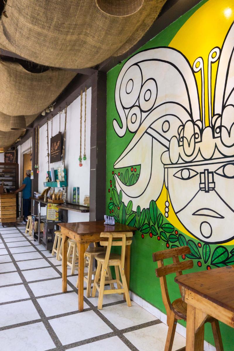 La Miga Bakery interior tables and art on the wall La Miga Bakery interior tables and art on the wall