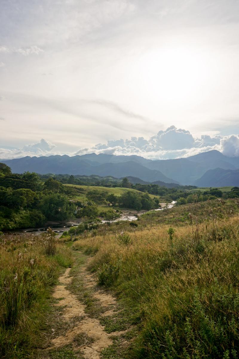 Dirt path with views of the countryside in Guadalupe, going downhill to Las Gachas river stream, during the afternoon. Dirt path with views of the countryside in Guadalupe, going downhill to Las Gachas river stream, during the afternoon.